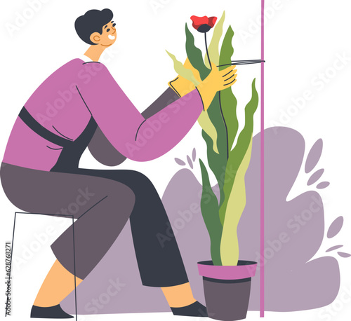 Gardener tending plants, florist shop or store