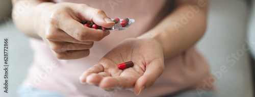 Healthcare Harmony: Close-Up Hands Holding Medication and Water Glass for Optimal Wellness, Pharmaceutical Treatment and mental health treatment photo