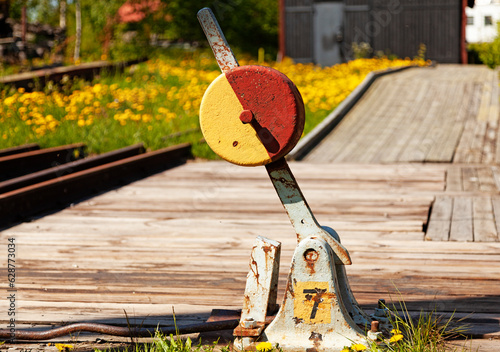 close-up switch part for train tracks in red and yellow photo