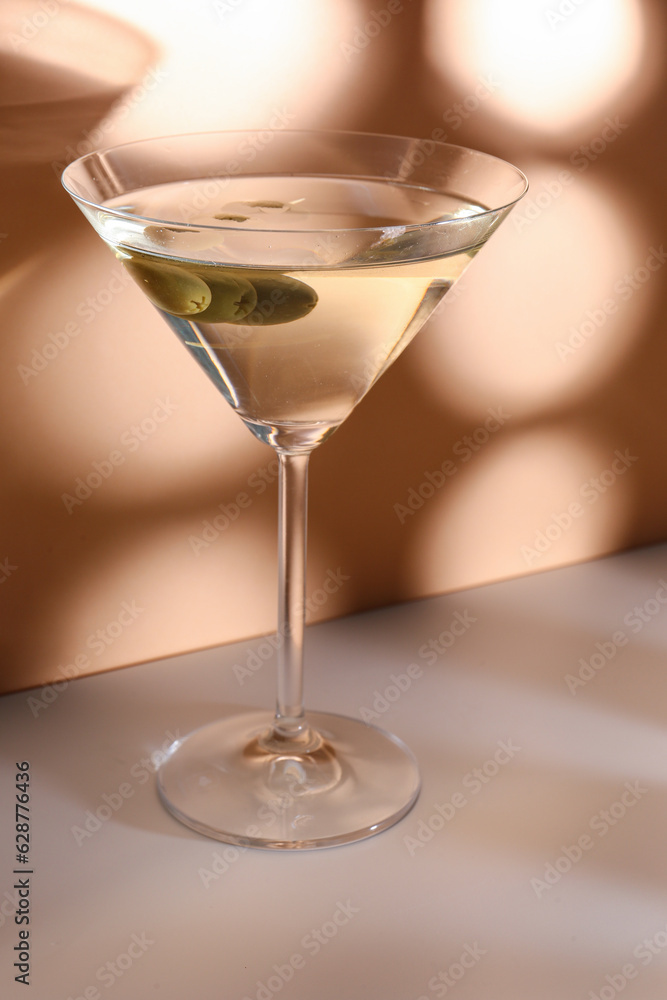 Glass of martini with olives on color background Glass of martini with olives on color background
