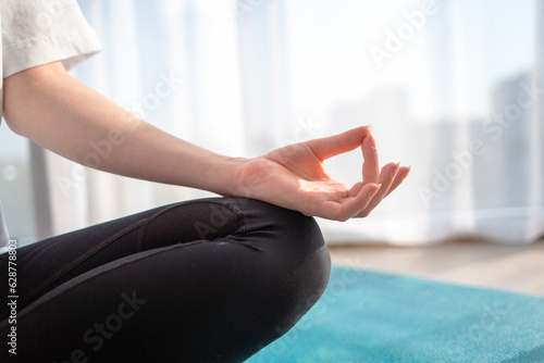 A woman is engaged in meditation. Close up of the hand. Indoor