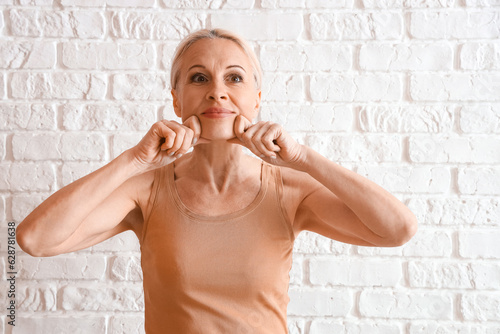Mature woman doing face bui...