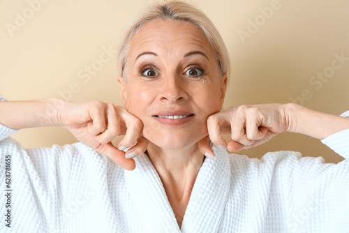 Mature woman doing face bui...