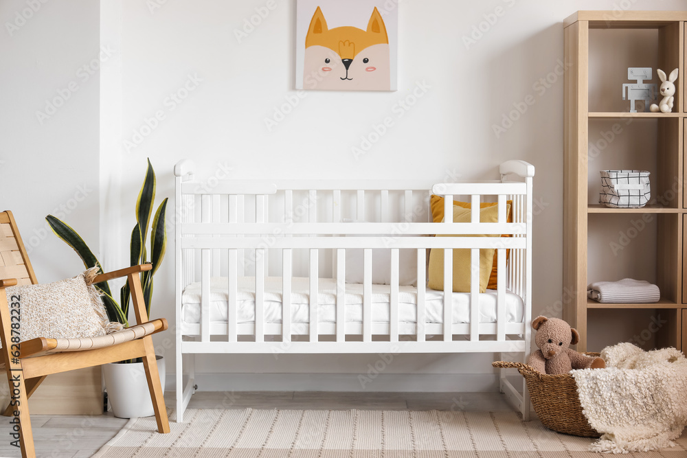 Interior of light bedroom with baby crib and shelving unit - obrazy, fototapety, plakaty 