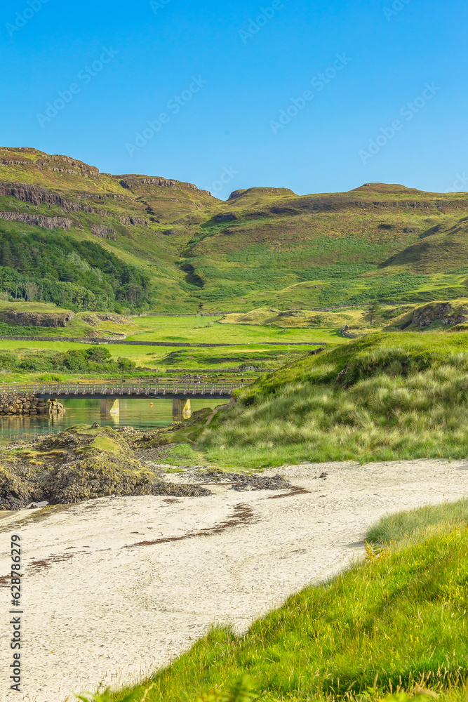 Portrait of Traigh Bhan, the beautiful white beach at Sanday on the Isle of Canna, Hebrides, Scotland with the bridge linking Canna to Sanday.  Vertical, Copy space.