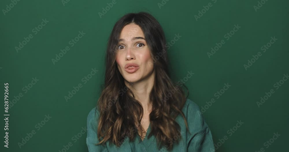 Perplexed dissatisfied woman looks frustrated at camera says I don't agree has puzzled face expression dressed casually isolated over green background. Girl shake her head. No, deny. Perplexed dissatisfied woman looks frustrated at camera says I don't agree has puzzled face expression dressed casually isolated over green background. Girl shake her head. No, deny.