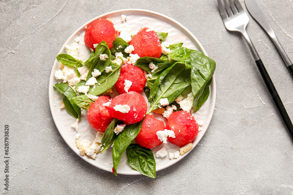 Plate of tasty watermelon salad on grey background Plate of tasty watermelon salad on grey background
