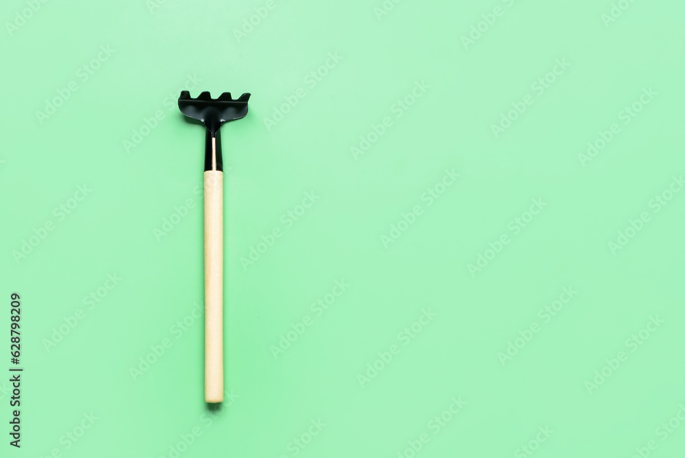 Gardening rake on green background Gardening rake on green background