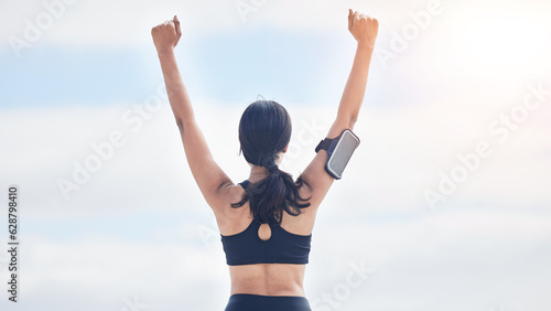 Fitness, celebration and woman with arms up in cloudy sky, mockup and winning achievement in nature. Ocean, goals and exercise girl for workout motivation, winner victory and success in natural space © JessicaLeigh J/peopleimages.com