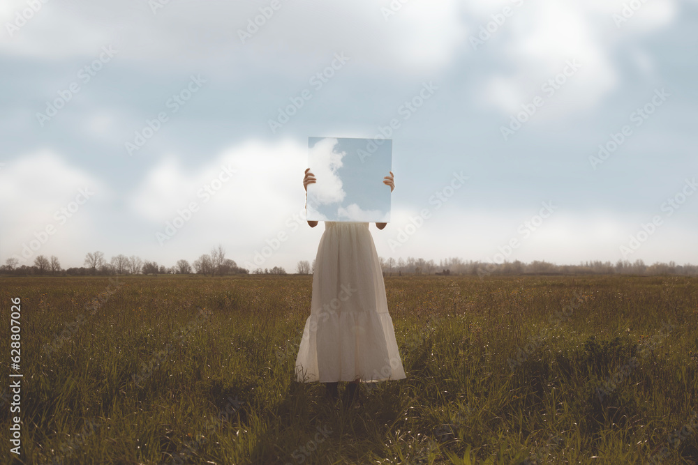 woman holding a surreal painting of the sky in front of her face, abstract concept