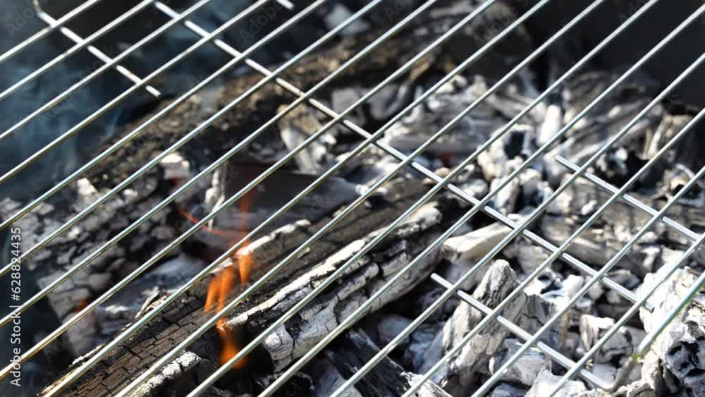 Close-up of the grill grate on the wood burning up Close-up of the grill grate on the wood burning up