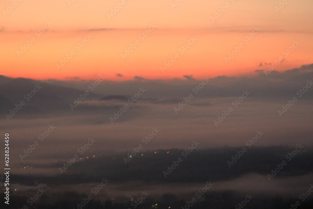 fog before sunrise and orange sky