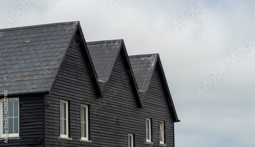 Wooden house roof attics against cloudy sky. Home residential building
