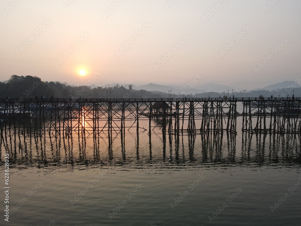 Mon Bridge, the longest wooden bridge in Thailand at Kanchanaburi Province with the morning sun