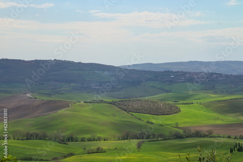 Italy , Tuscany , Val D'Orcia, 25 April 2023: Stunning view of green fields. Summer rural landscape of hills and cypresses. © Imma