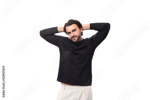 young bearded brutal european macho man with ear piercing and with black hair on isolated white background with copy space