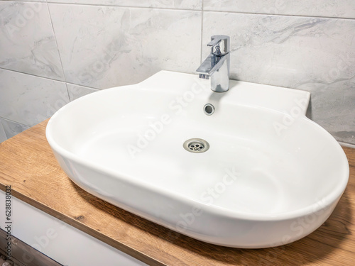 white modern bathroom sink and faucet