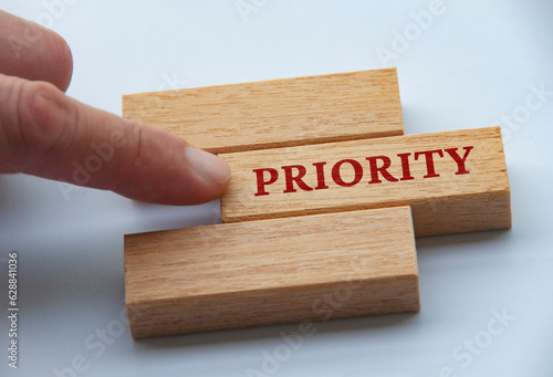 Картината върху платно Finger pushing wooden blocks with text - Priority