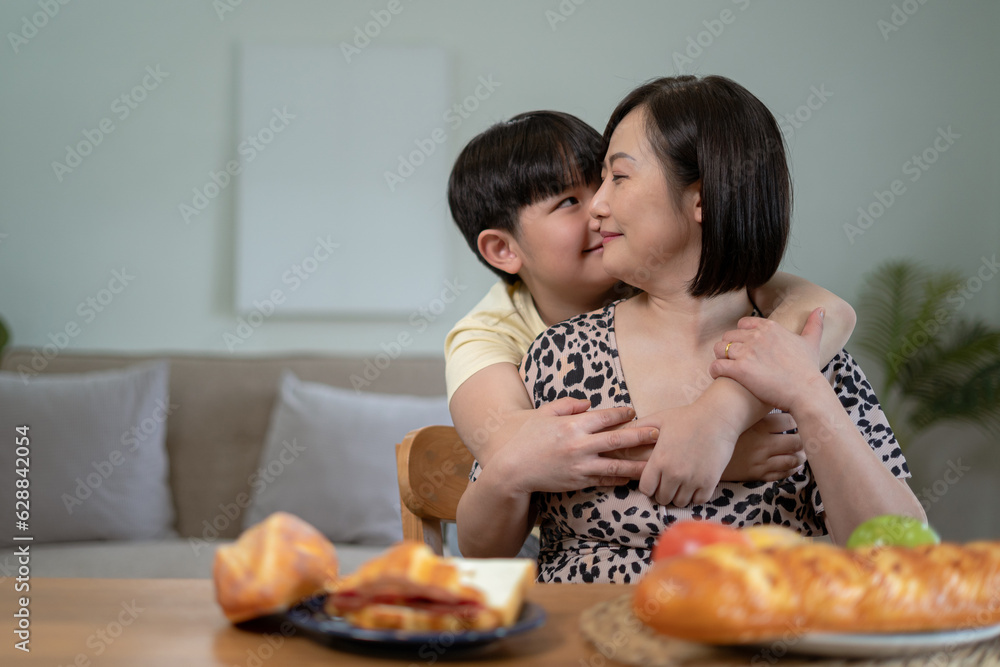 Son kissing happy mother, holiday at home Son kissing happy mother, holiday at home