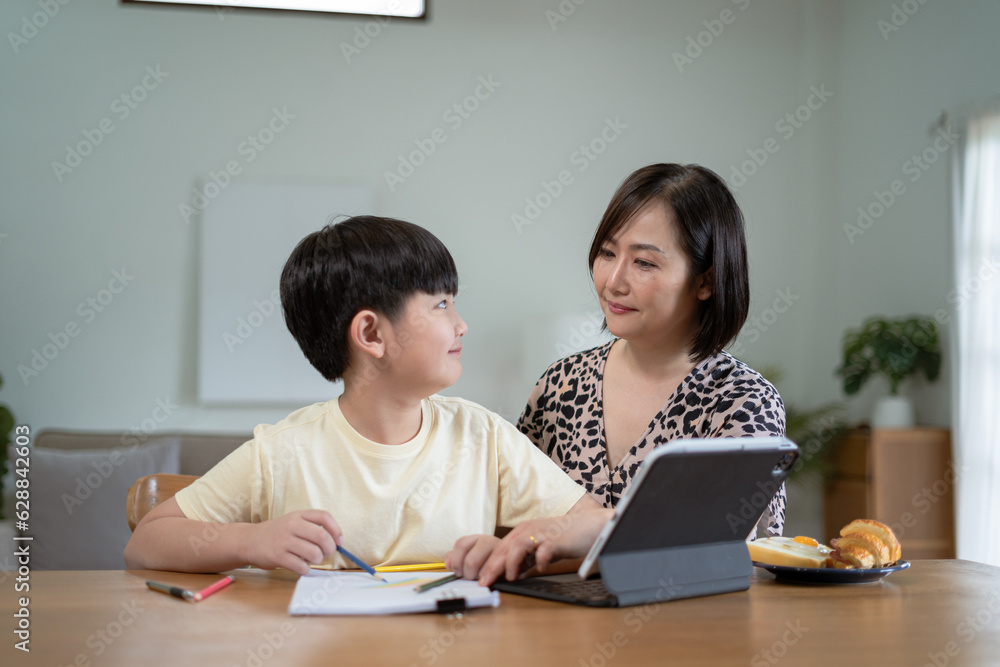 Happy family mom and son reading a book on holiday Happy family mom and son reading a book on holiday