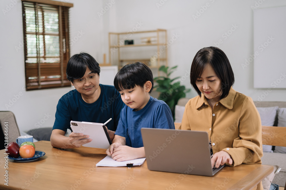 work from home education concept and family at home sitting at desk business woman working on internet in laptop child writing in notebook work from home education concept and family at home sitting at desk business woman working on internet in laptop child writing in notebook