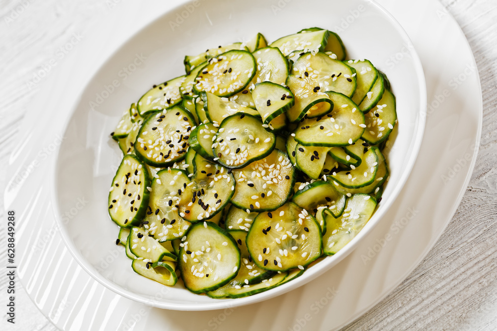 Sunomono, Japanese Cucumber Salad in a white bowl Sunomono, Japanese Cucumber Salad in a white bowl