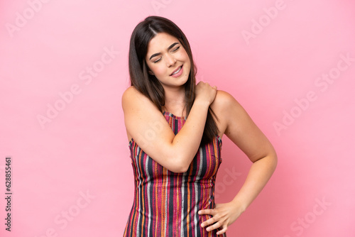 Young Brazilian woman isolated on pink background suffering from pain in shoulder for having made an effort © luismolinero