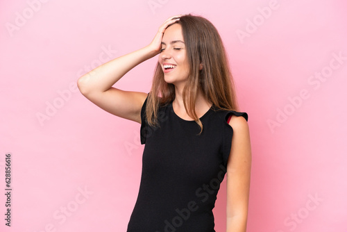 Young caucasian woman isolated on pink background smiling a lot