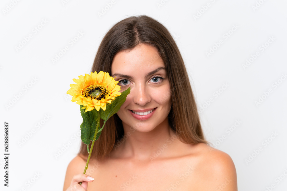 Young caucasian woman isolated on white background holding a sunflower while smiling. Close up portrait Young caucasian woman isolated on white background holding a sunflower while smiling. Close up portrait