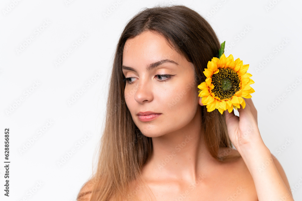 Young caucasian woman isolated on white background holding a sunflower. Close up portrait Young caucasian woman isolated on white background holding a sunflower. Close up portrait