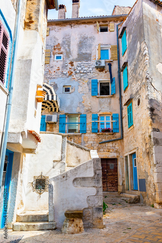 Medieval courtyard in the historical part of Rovinj, blue windows with shutters © sherlesi 
