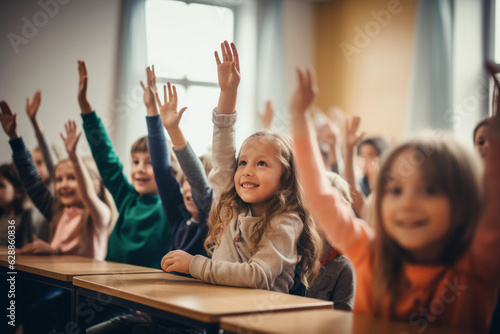 Students raising their hands in class at the elementary school