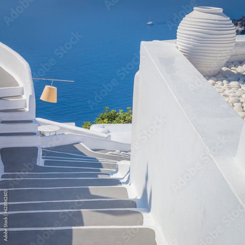Greece, Santorini island, Oia - white architecture of a narrow street, steps lead to the sea. Greek Islands, Santorini
