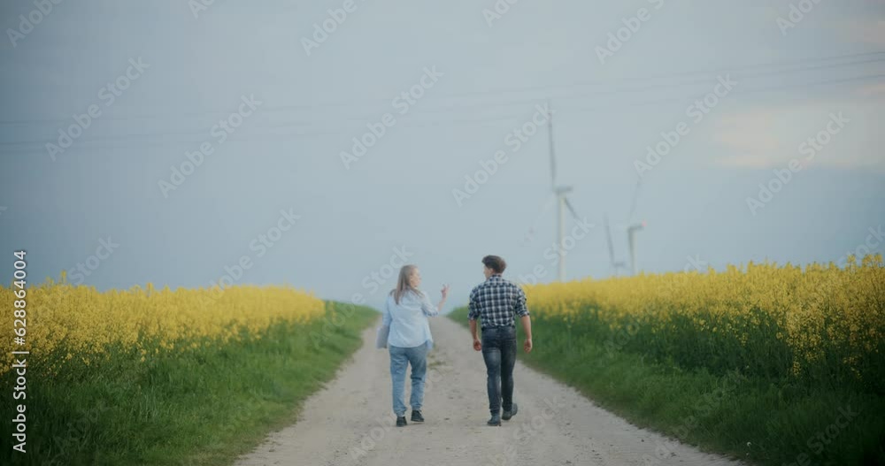 Farmer With Agronomist On Road Amidst Plants At Farm. Farmer With Agronomist On Road Amidst Plants At Farm.