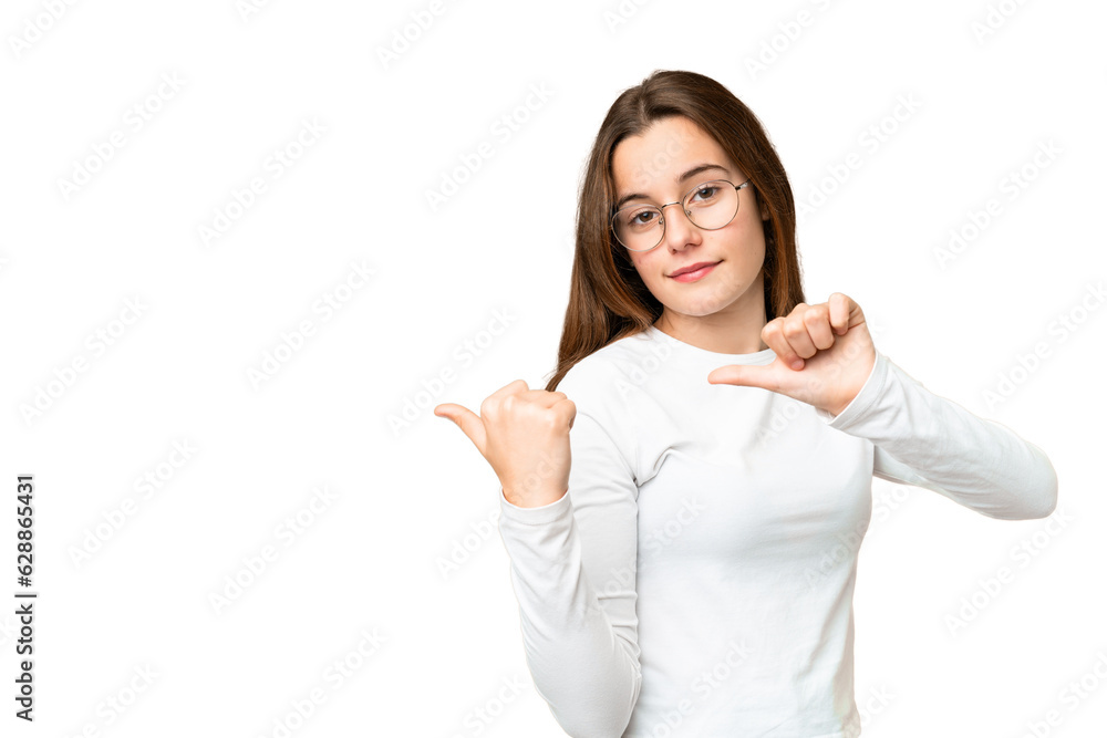 Teenager girl over isolated chroma key background pointing to the side to present a product Teenager girl over isolated chroma key background pointing to the side to present a product