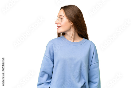 Teenager girl over isolated chroma key background looking side