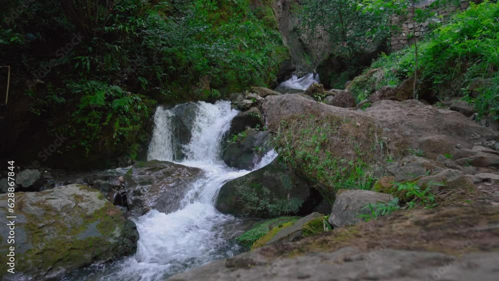 Wild river in mountain forest. River flow. Mountain forest river. River stream flows in humid forest at foot of mountains, shrouded in greenery and vegetation. Motion Camera. Wild river in mountain forest. River flow. Mountain forest river. River stream flows in humid forest at foot of mountains, shrouded in greenery and vegetation. Motion Camera.