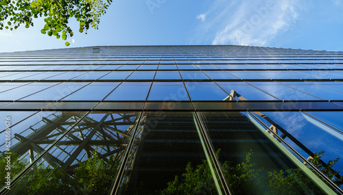 View upwards of a modern facade of an office building and trees