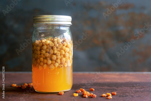 Fotografija raisins wild yeast water starter in a glass jar for sourdough artisan bread
