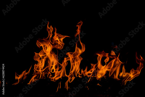 Fire blaze flames on black background. Fire burn flame isolated, abstract texture. Flaming explosion with burning effect. Fire wallpaper, abstract art pattern with copy space.