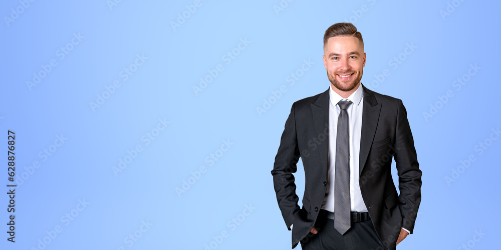 Smiling businessman portrait hands in pocket on empty blue background Smiling businessman portrait hands in pocket on empty blue background