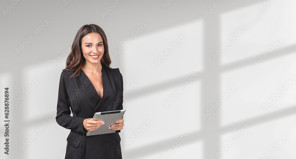 Businesswoman with tablet in hands, smiling portrait on empty wh Businesswoman with tablet in hands, smiling portrait on empty wh