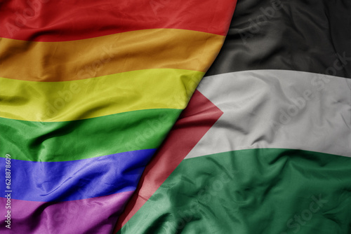 big waving realistic national colorful flag of palestine and rainbow gay pride flag .