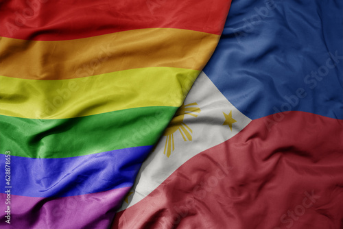 big waving realistic national colorful flag of philippines and rainbow gay pride flag .