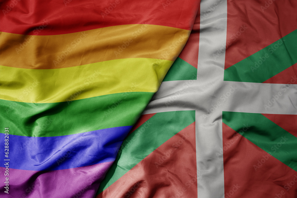 big waving realistic national colorful flag of basque country and rainbow gay pride flag .