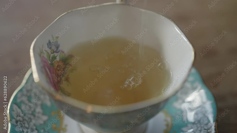 Pouring Hot Tea into Cup Cups and Teapot Teapots in Slow Motion Pouring Hot Tea into Cup Cups and Teapot Teapots in Slow Motion