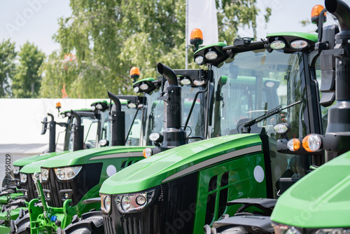 A row of green agricultural tractors