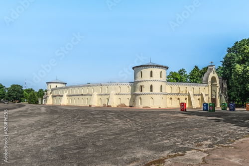 Trostyanets, Sumy Oblast, Ukraine - June 18, 2023: View from Vulytsya Myru street on the facade of the Round Court in Trostianets. Square in front of Krugliy dvir fortress in summer photo