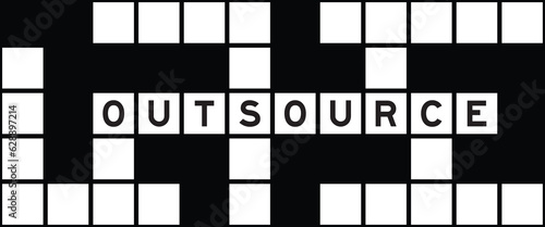 Alphabet letter in word outsource on crossword puzzle background
