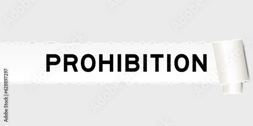 Ripped gray paper background that have word prohibition under torn part